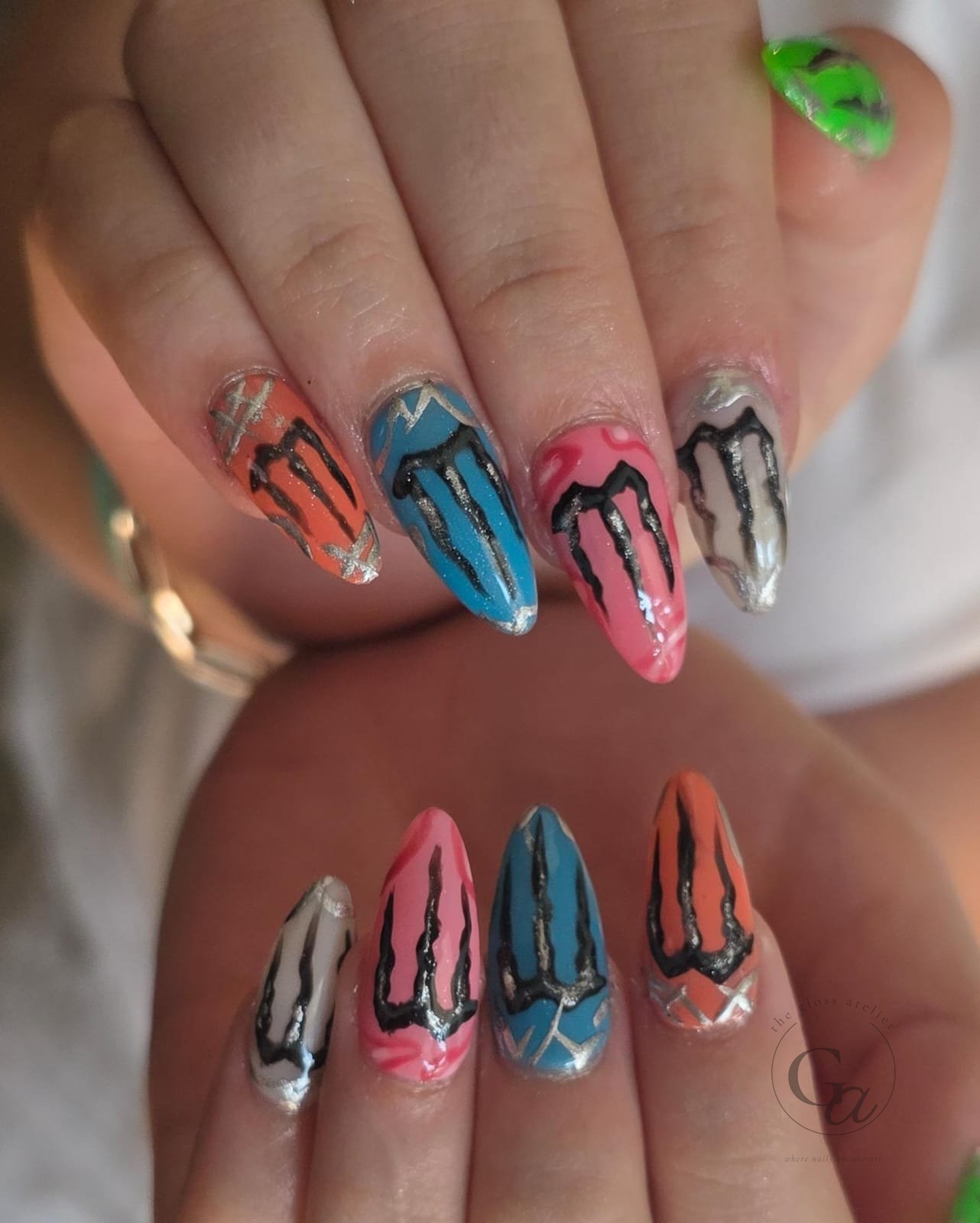 Almond set in orange, teal, pink and nude with hand-painted black claw marks and silver chrome.