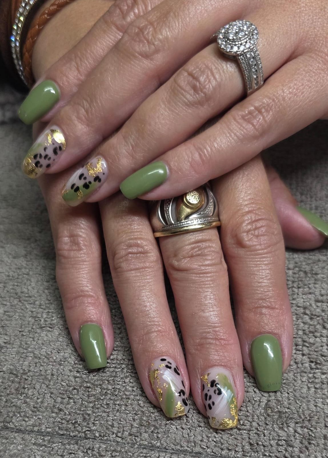 Sage-green coffin nails with leopard print and gold-leaf accents.