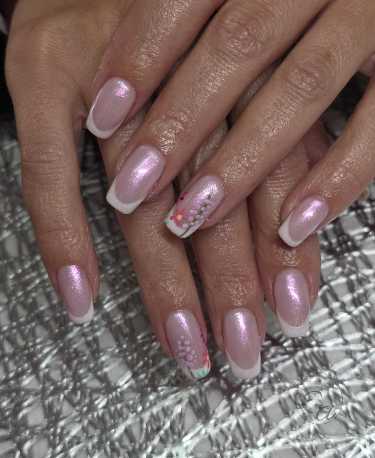 Pink pearl shimmer nails with white French tips and hand-painted wildflowers.