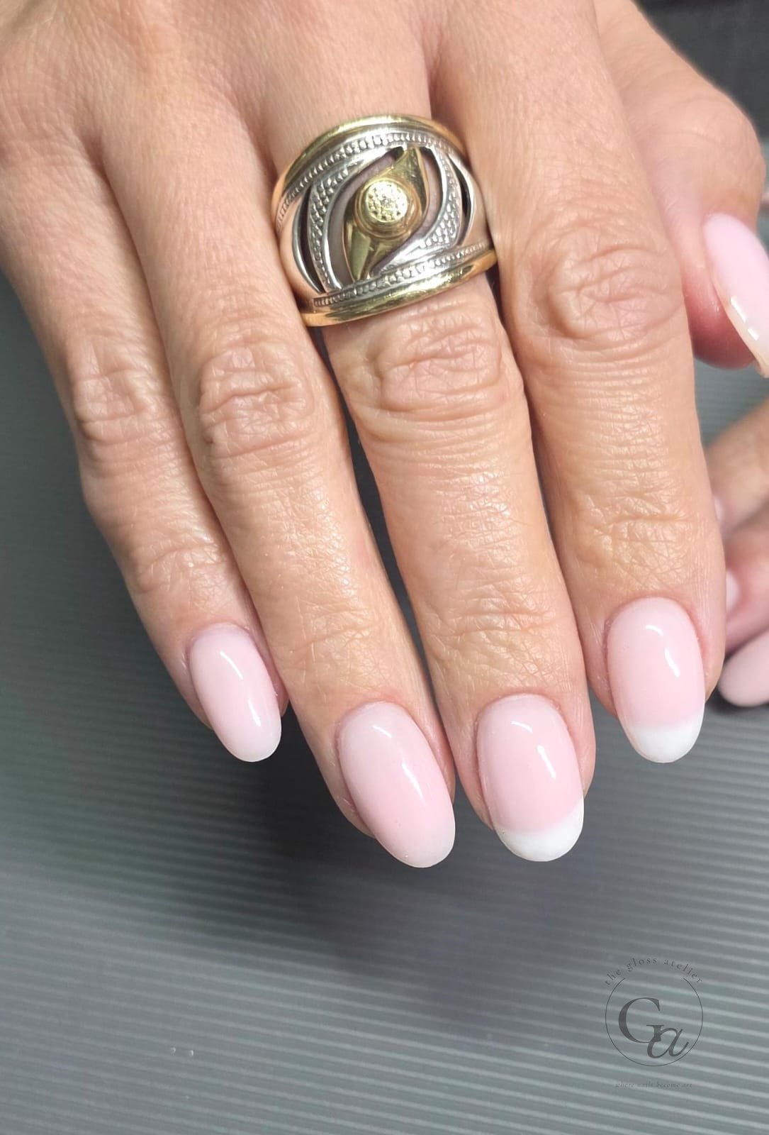 Soft pink oval nails with a clean white French tip.